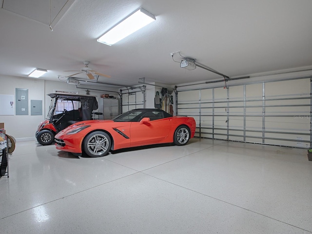 garage featuring electric panel, ceiling fan, and a garage door opener