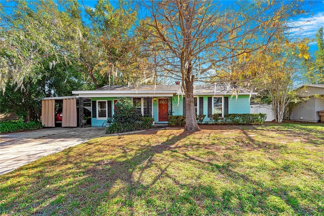 ranch-style house with a carport and a front lawn