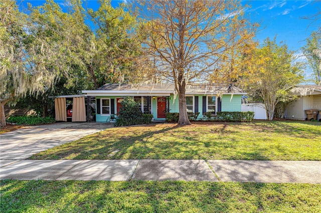 ranch-style home with a front lawn and a carport