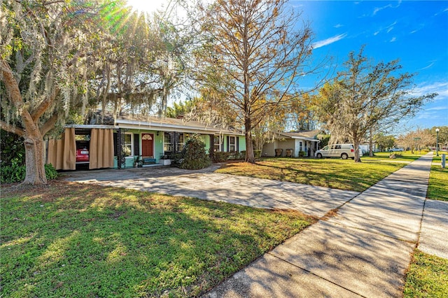 single story home with a front lawn and a carport