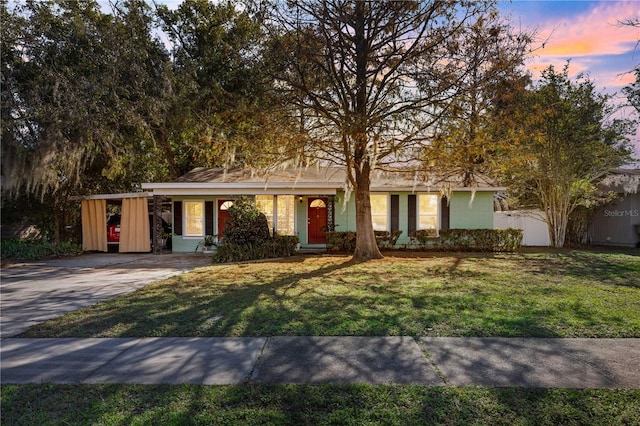 single story home with a yard and a carport