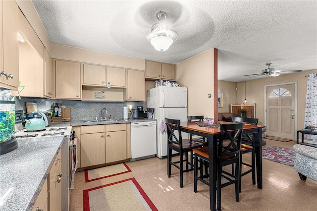 kitchen with tasteful backsplash, white appliances, a textured ceiling, sink, and light brown cabinets