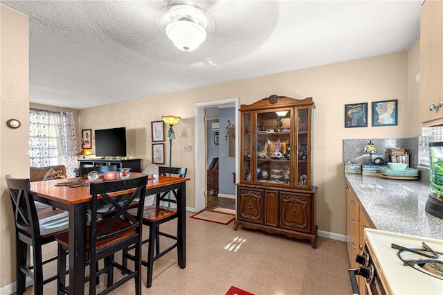 dining space with a textured ceiling and ceiling fan