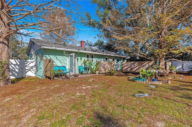 rear view of house with a lawn