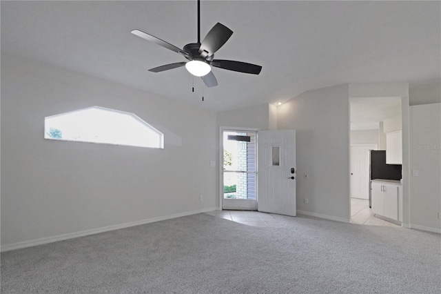 carpeted empty room featuring ceiling fan and lofted ceiling