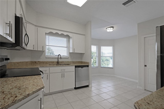 kitchen with sink, white cabinetry, stainless steel appliances, and light tile patterned floors