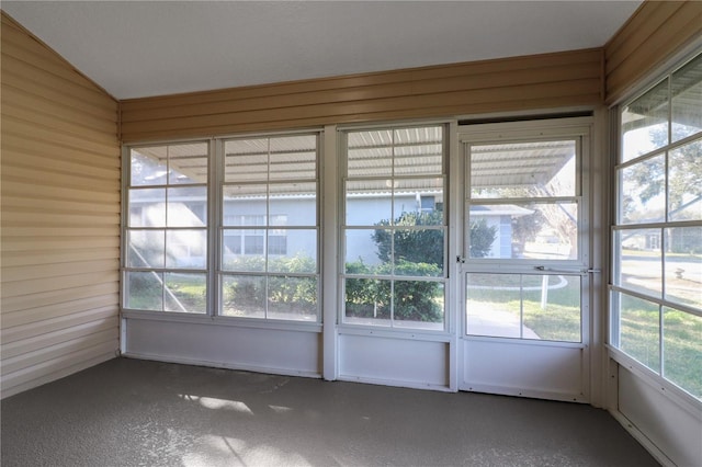 unfurnished sunroom with lofted ceiling