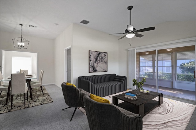 living room featuring carpet, ceiling fan with notable chandelier, and lofted ceiling