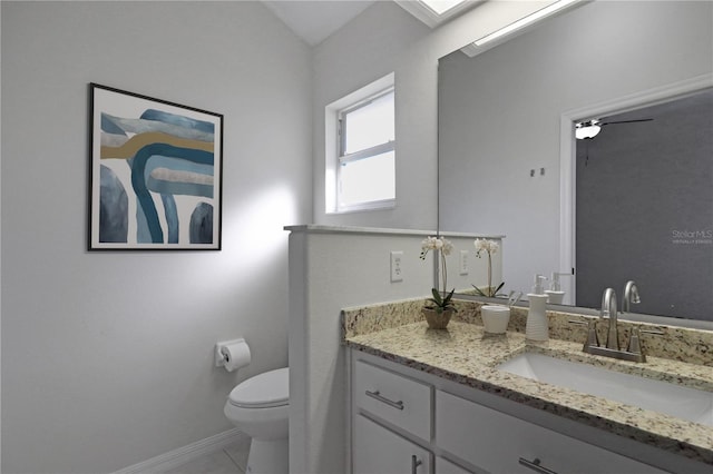 bathroom with tile patterned flooring, vanity, and toilet