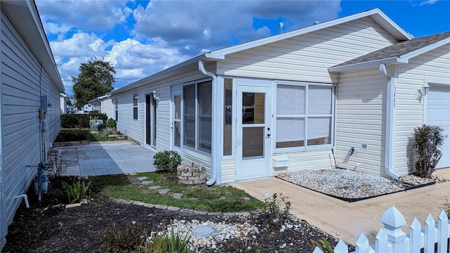 view of side of property with a patio area