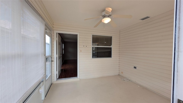 unfurnished sunroom featuring ceiling fan