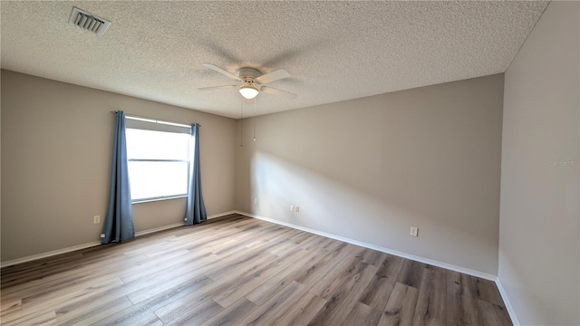 unfurnished room featuring ceiling fan, a textured ceiling, and light wood-type flooring