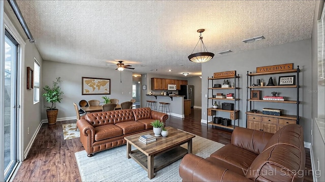 3449 Roanoke St, The Villages, FL 32162 - living area with visible vents, ceiling fan, and wood finished floors