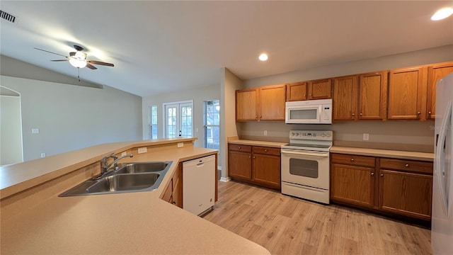 kitchen featuring lofted ceiling, sink, white appliances, ceiling fan, and light wood-type flooring