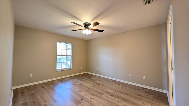 spare room featuring ceiling fan and light hardwood / wood-style flooring