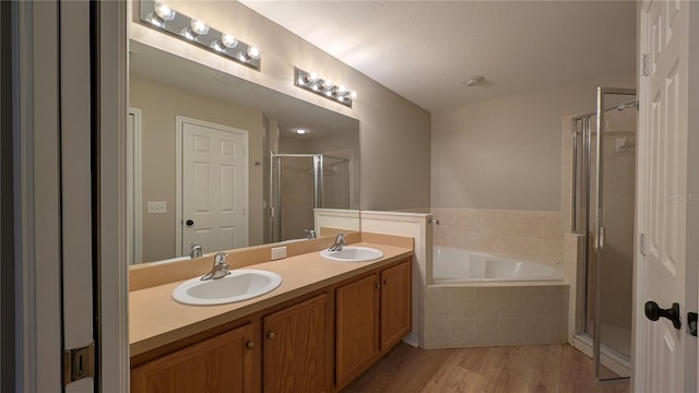 bathroom featuring vanity, hardwood / wood-style floors, and separate shower and tub