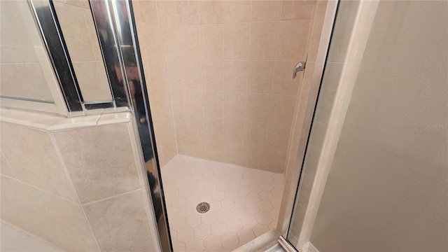 bathroom with tiled shower