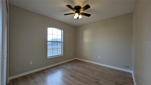 spare room featuring ceiling fan and light hardwood / wood-style flooring