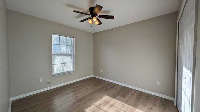 spare room featuring ceiling fan and light hardwood / wood-style floors