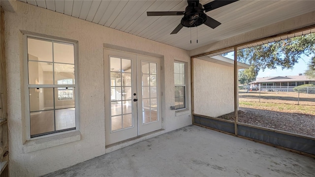 unfurnished sunroom with ceiling fan and french doors