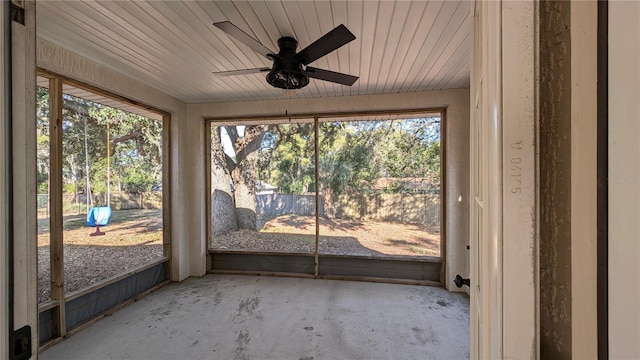 unfurnished sunroom featuring ceiling fan and wooden ceiling