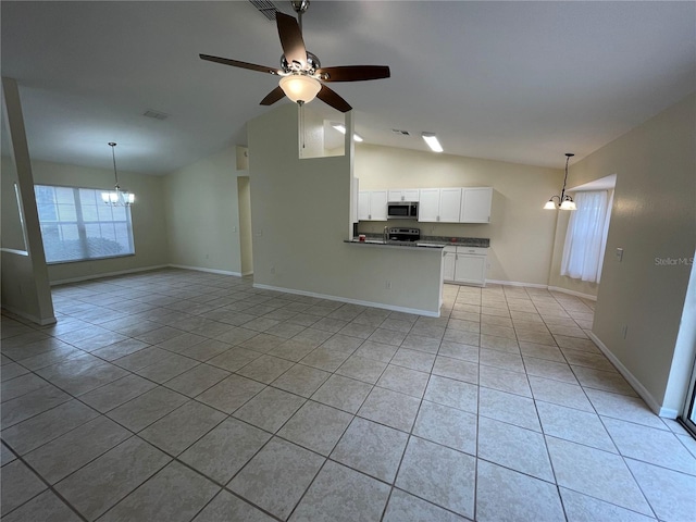 unfurnished living room with vaulted ceiling, light tile patterned floors, and ceiling fan with notable chandelier