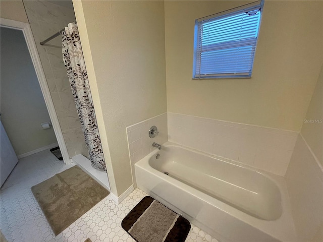 bathroom featuring tile patterned flooring and separate shower and tub