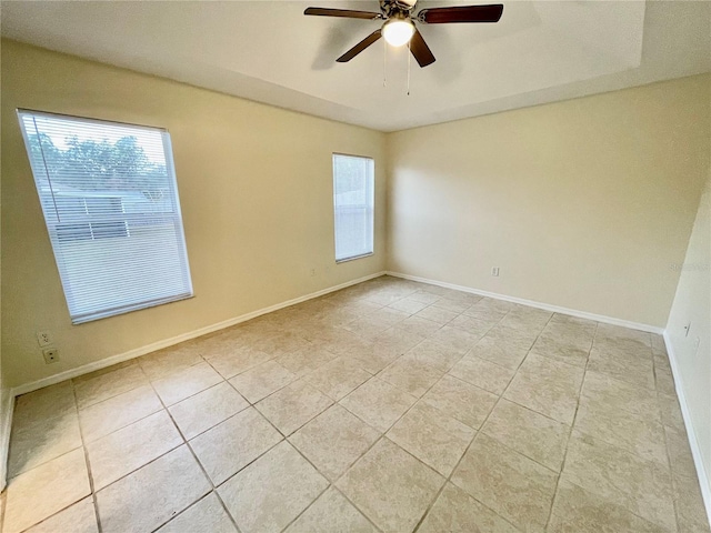 tiled empty room featuring ceiling fan