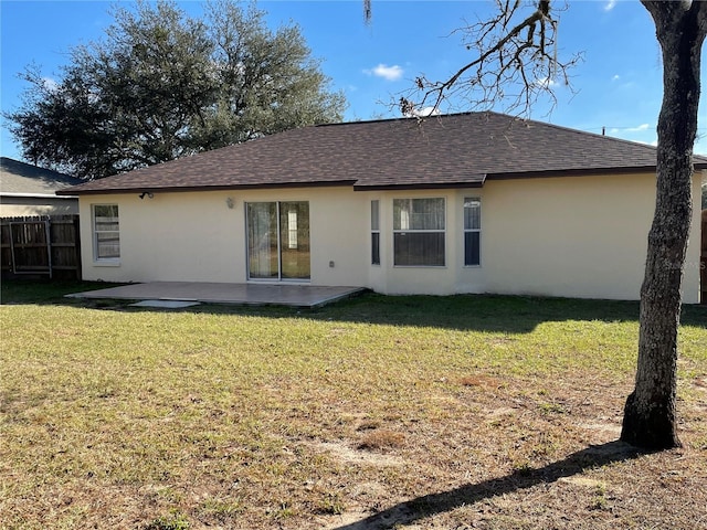 back of property featuring a lawn and a patio area