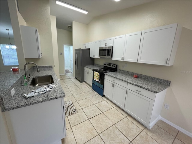 kitchen with white cabinets, appliances with stainless steel finishes, light tile patterned floors, and sink