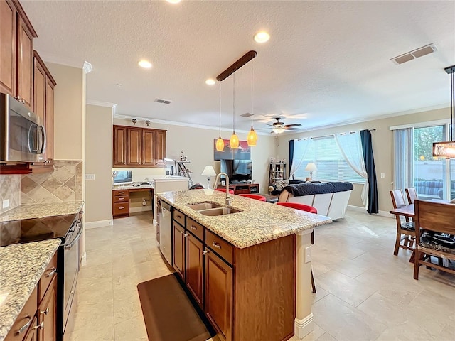 kitchen featuring sink, hanging light fixtures, crown molding, a kitchen island with sink, and appliances with stainless steel finishes