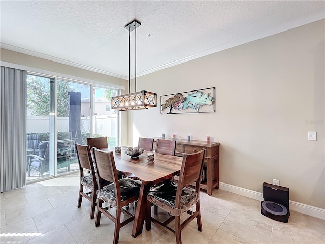 tiled dining room featuring ornamental molding and a textured ceiling