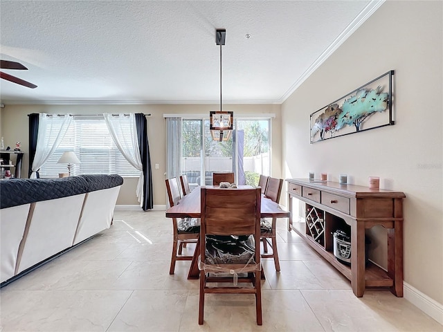 dining space featuring ceiling fan, crown molding, light tile patterned floors, and a textured ceiling