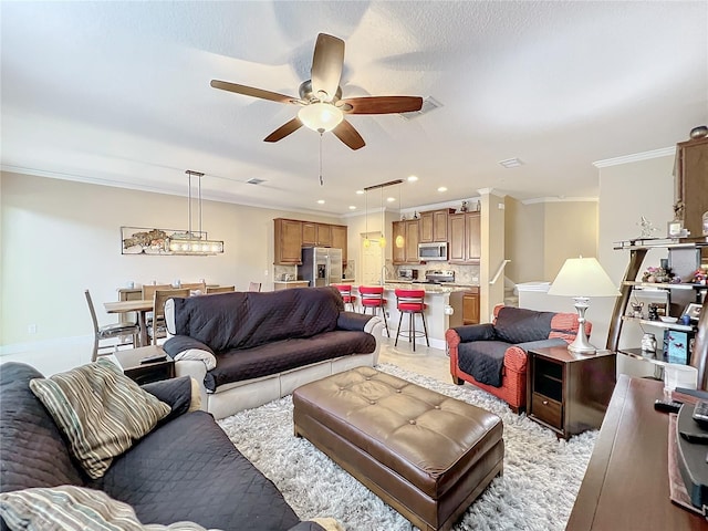 living room with ceiling fan and crown molding