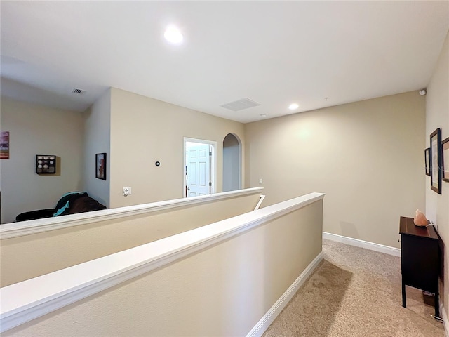 hall featuring light colored carpet