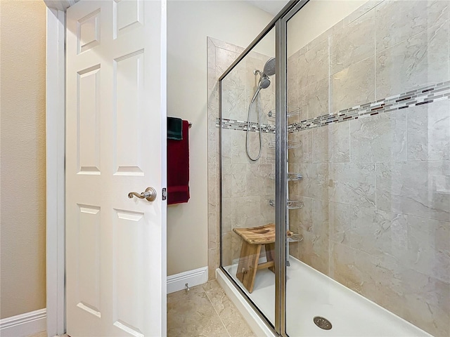 bathroom with a shower with door