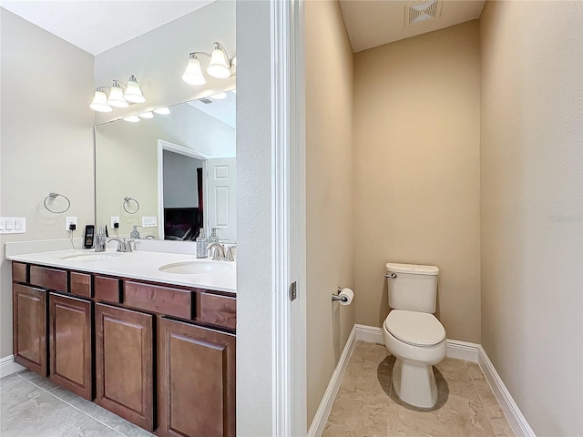 bathroom featuring vanity and toilet