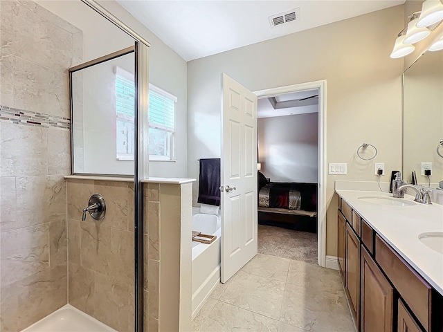 bathroom featuring shower with separate bathtub and vanity