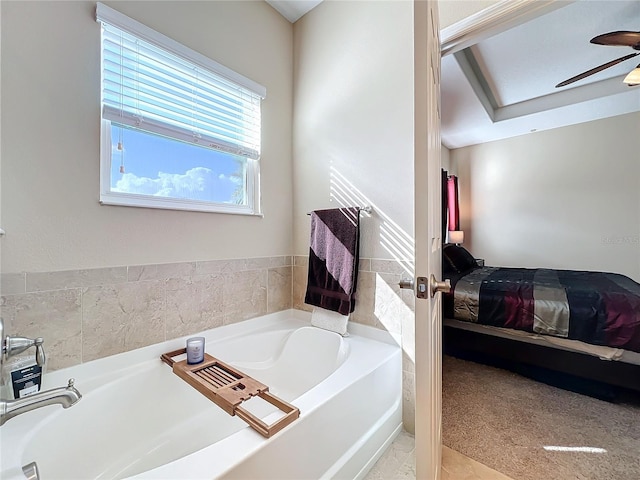 bathroom featuring a tub to relax in and ceiling fan