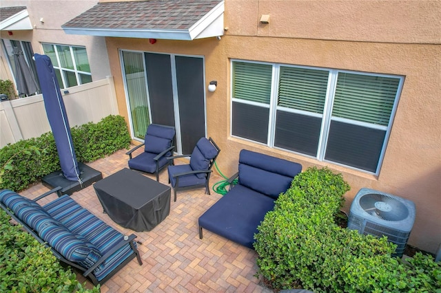 view of patio / terrace with central air condition unit and an outdoor living space