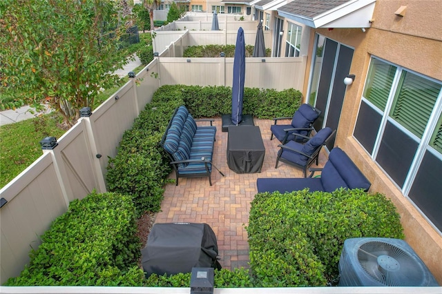 view of patio featuring central air condition unit and a grill