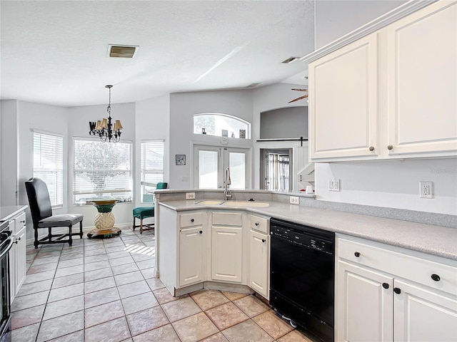 kitchen with dishwasher, white cabinetry, sink, and light tile patterned floors