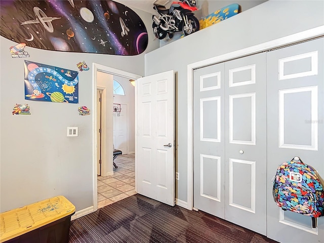 interior space featuring dark tile patterned flooring