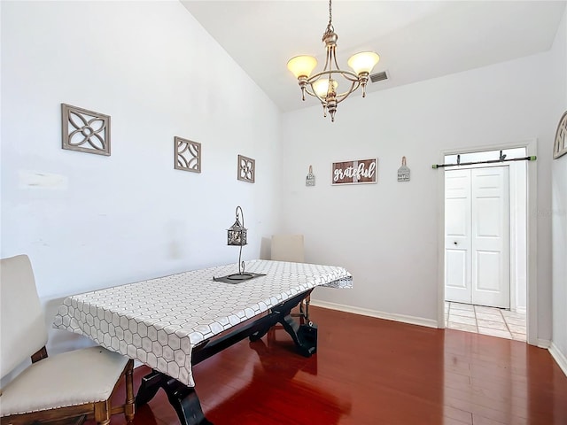 dining area featuring a chandelier and hardwood / wood-style flooring