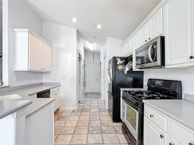 kitchen with white cabinets, light tile patterned flooring, and black appliances