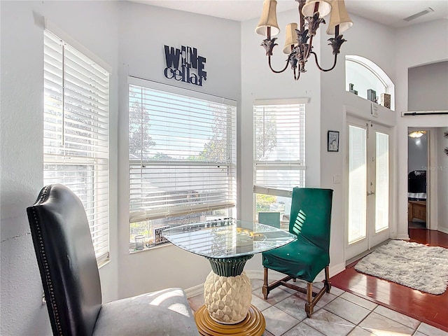 dining room featuring a chandelier, plenty of natural light, and light tile patterned flooring