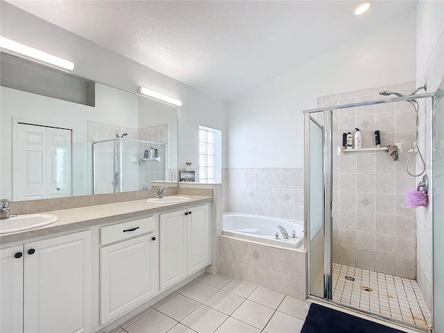 bathroom featuring tile patterned floors, plus walk in shower, and vanity