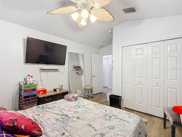 bedroom featuring hardwood / wood-style flooring, ceiling fan, a closet, and vaulted ceiling