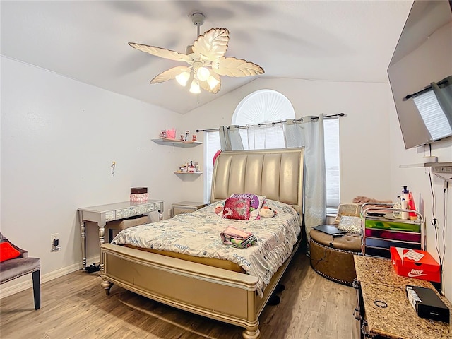 bedroom featuring ceiling fan, lofted ceiling, and light wood-type flooring