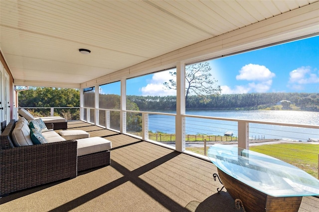 sunroom / solarium featuring a water view